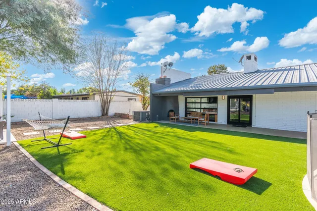 a view of an house with swimming pool and sitting area