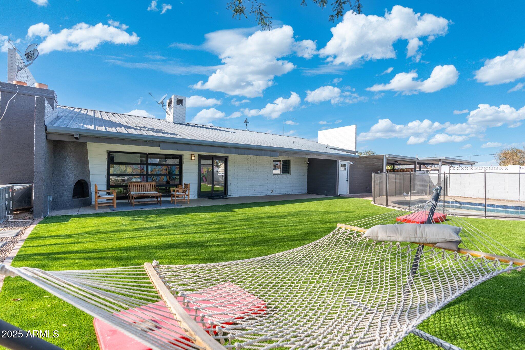 1759 North Spring Circle Mesa, AZ 85203 - Photo 31 of 69 a view of a house with backyard porch and patio