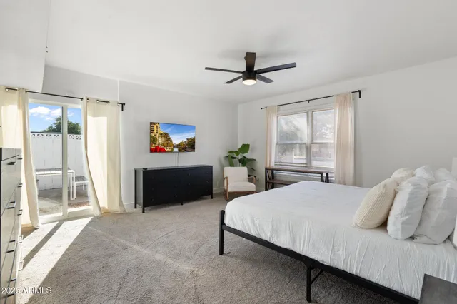 a living room with furniture a rug and white walls