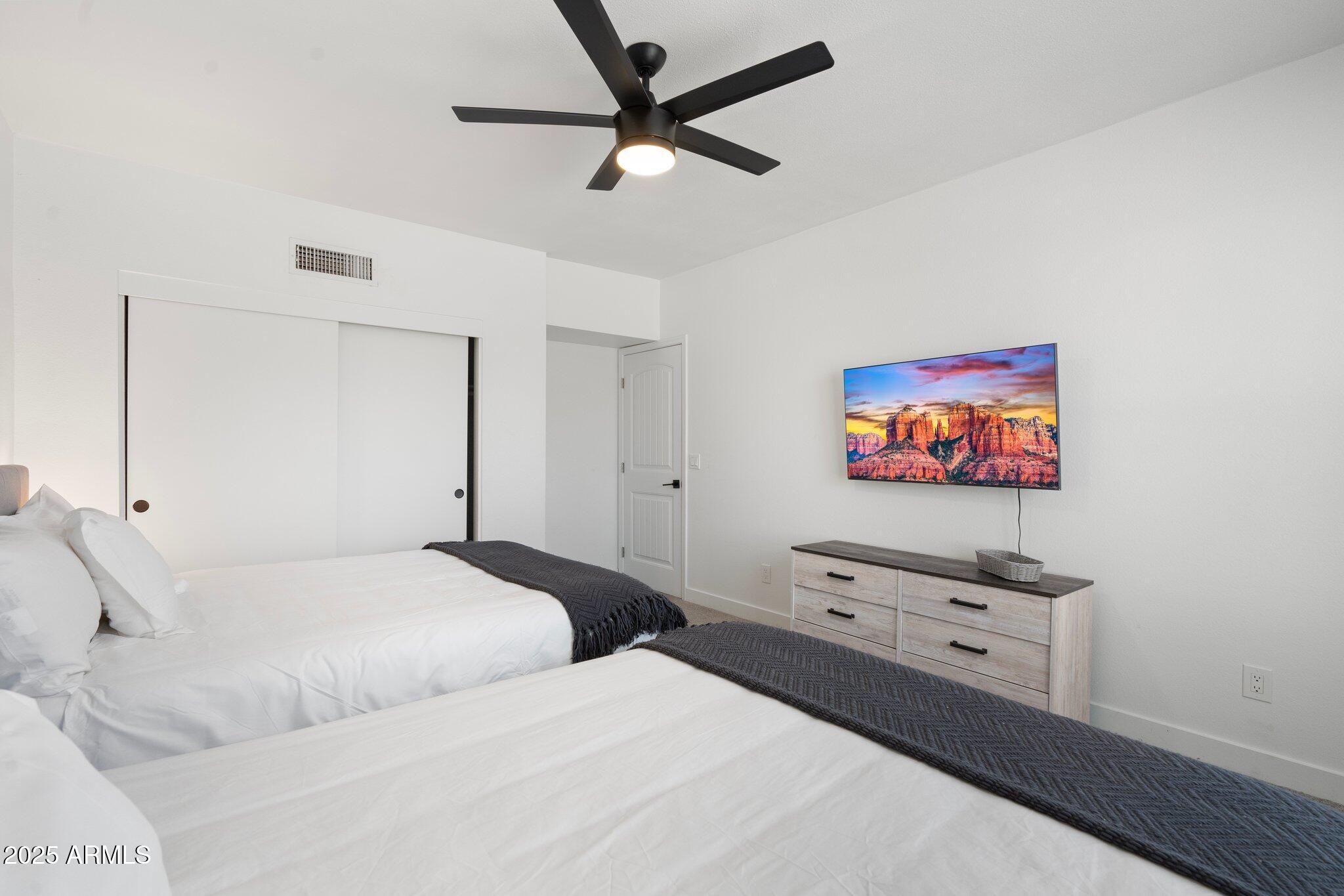 1759 North Spring Circle Mesa, AZ 85203 - Photo 42 of 69 a bedroom with a bed and a painting on the wall