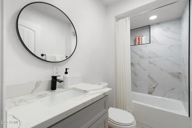 a kitchen with stainless steel appliances granite countertop a table chairs microwave and refrigerator