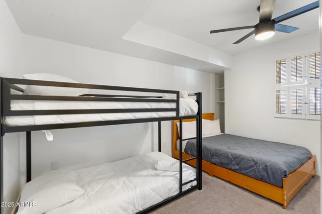 a kitchen with stainless steel appliances a white table chairs and a refrigerator