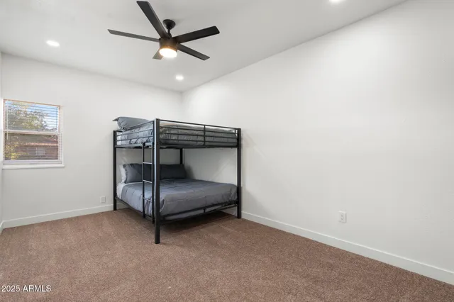 a kitchen with white cabinets sink and stainless steel appliances