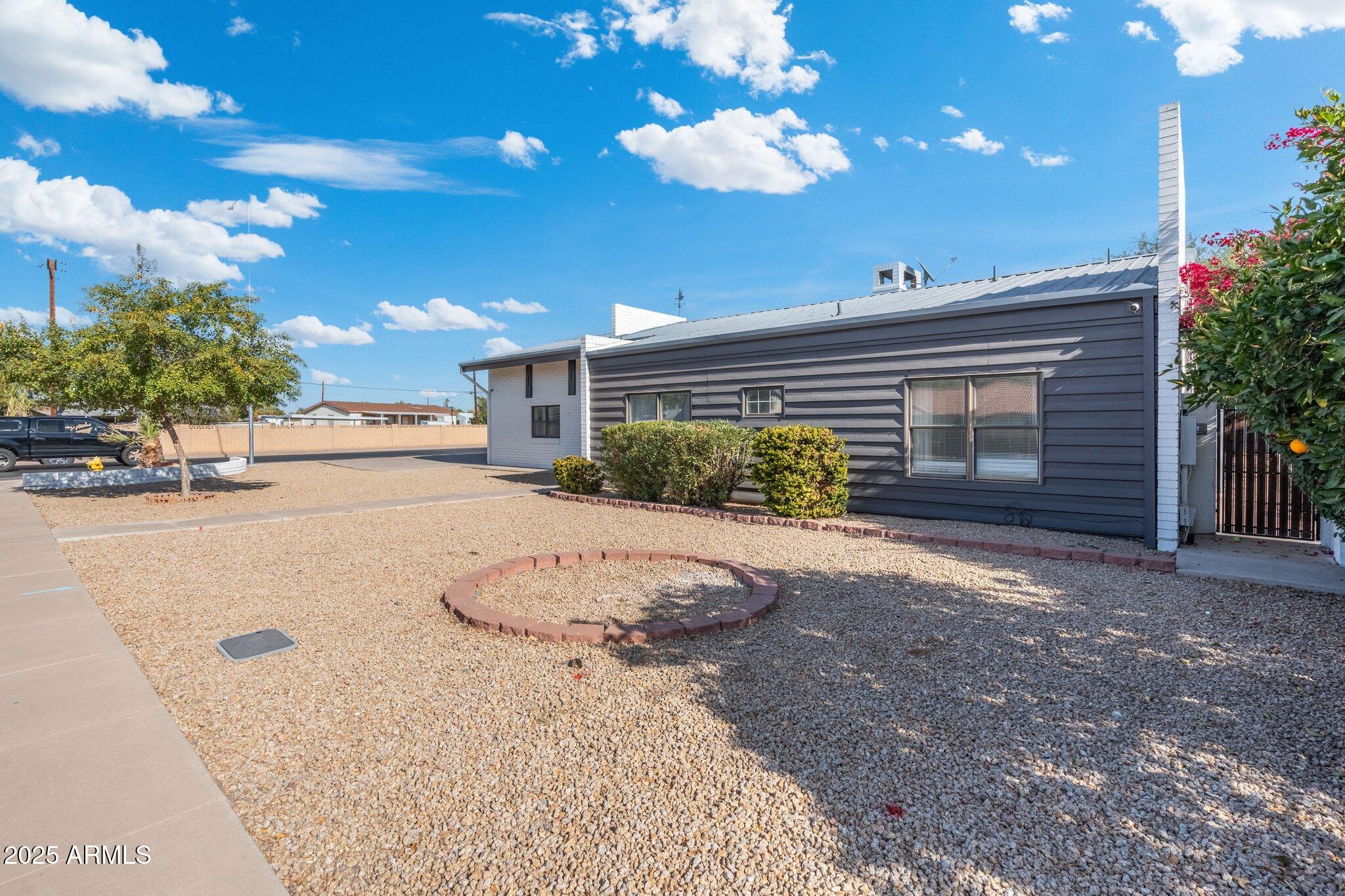 1759 North Spring Circle Mesa, AZ 85203 - Photo 67 of 69 a view of a house with a yard and garage