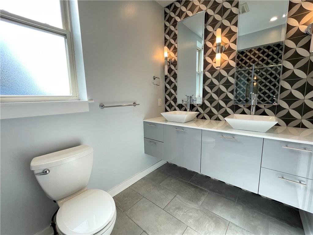 6026 Butler Street, Unit 3 Pittsburgh, PA 15201 - Photo 4 of 6 a bathroom with a sink toilet and shower