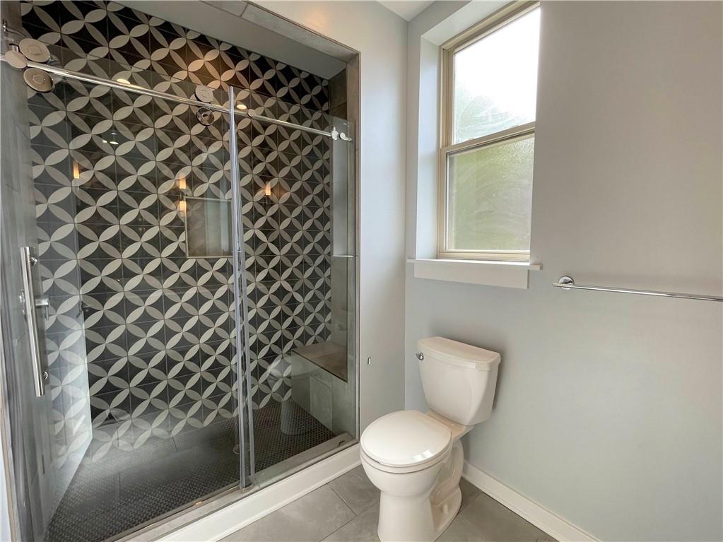 6026 Butler Street, Unit 3 Pittsburgh, PA 15201 - Photo 6 of 6 a white toilet sitting next to a window