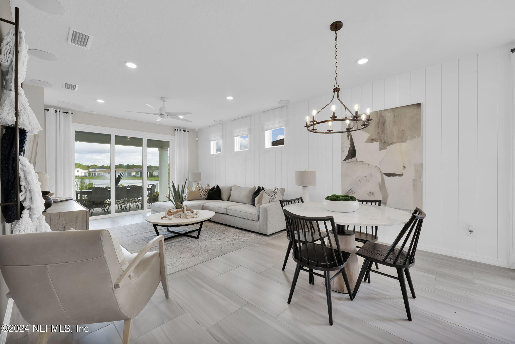 307 Fairlake Circle St. Augustine, FL 32092 - Photo 8 of 38 a living room with furniture a window and a chandelier