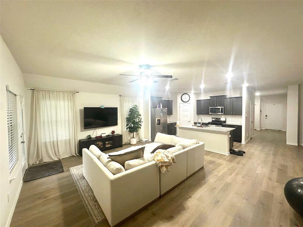 324 Revolution Road Fate, TX 75189 - Photo 3 of 15 Open-concept living area featuring wood-finish flooring, recessed lighting, and a ceiling fan