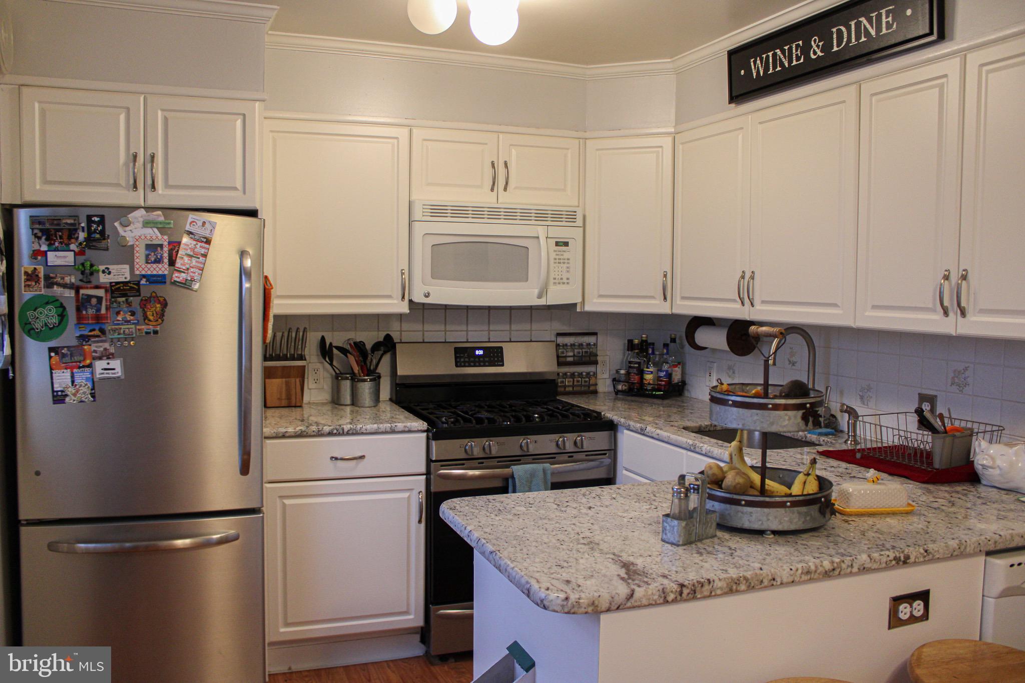 10830 Perrin Road Philadelphia, PA 19154 - Photo 11 of 24 a kitchen with granite countertop a refrigerator stove and sink