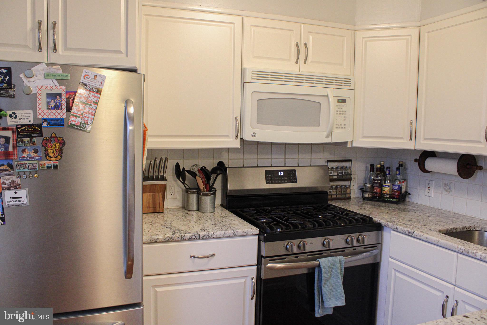 10830 Perrin Road Philadelphia, PA 19154 - Photo 12 of 24 a kitchen with granite countertop a stove and cabinets