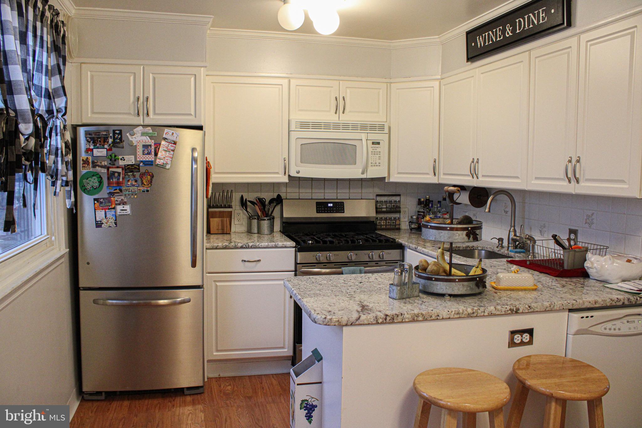 10830 Perrin Road Philadelphia, PA 19154 - Photo 9 of 24 a kitchen with stainless steel appliances granite countertop a refrigerator a stove a sink and white cabinets