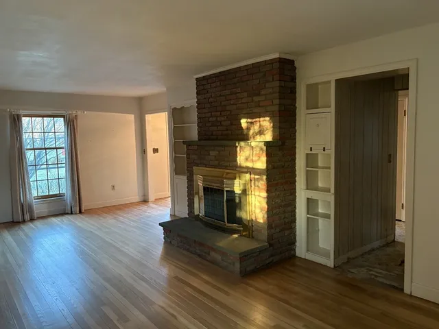 a wooden house with trees in front of it