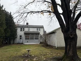 a view of house with backyard