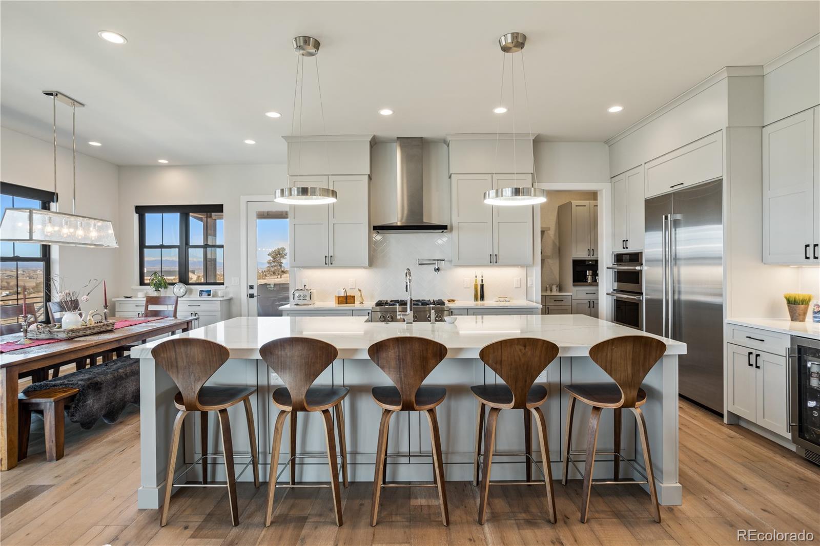 10621 Lone Fox Road Franktown, CO 80116 - Photo 13 of 50 a large kitchen with a table and chairs