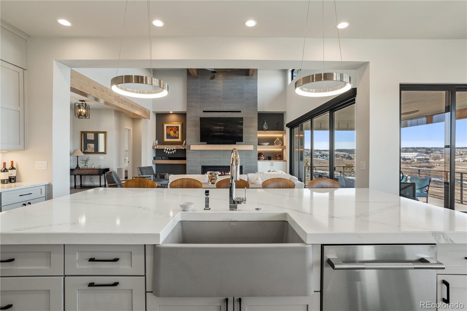 10621 Lone Fox Road Franktown, CO 80116 - Photo 14 of 50 a kitchen with stainless steel appliances granite countertop a sink and a refrigerator