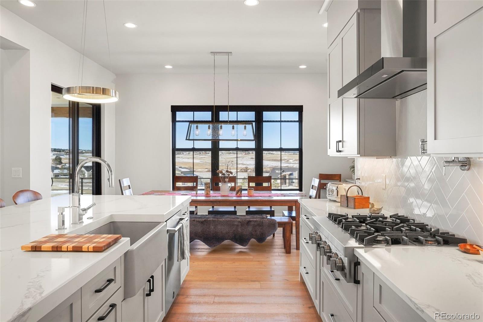 10621 Lone Fox Road Franktown, CO 80116 - Photo 17 of 50 a kitchen with stainless steel appliances a stove a sink and a refrigerator