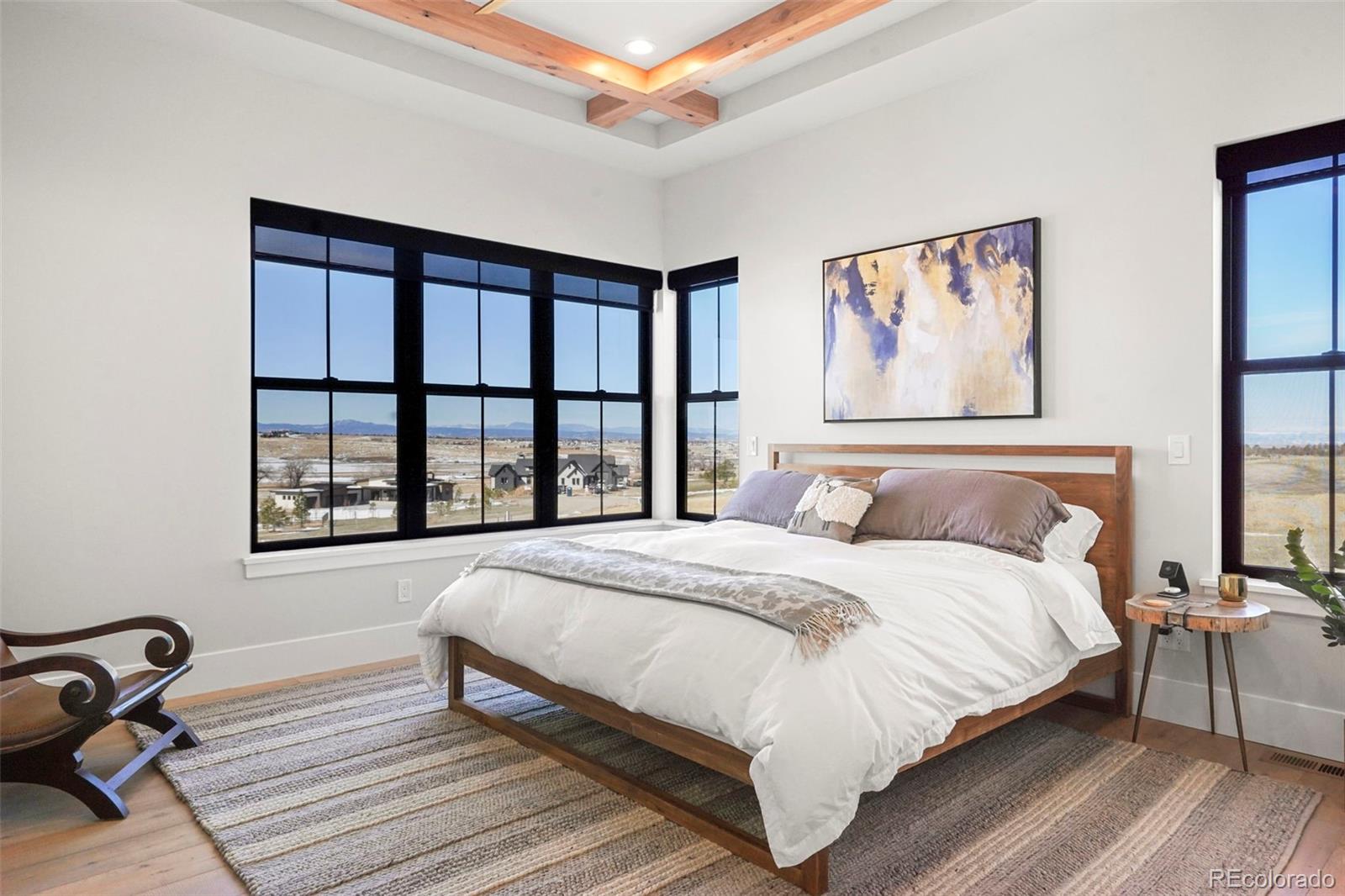 10621 Lone Fox Road Franktown, CO 80116 - Photo 21 of 50 a bedroom with a bed wooden floor and window