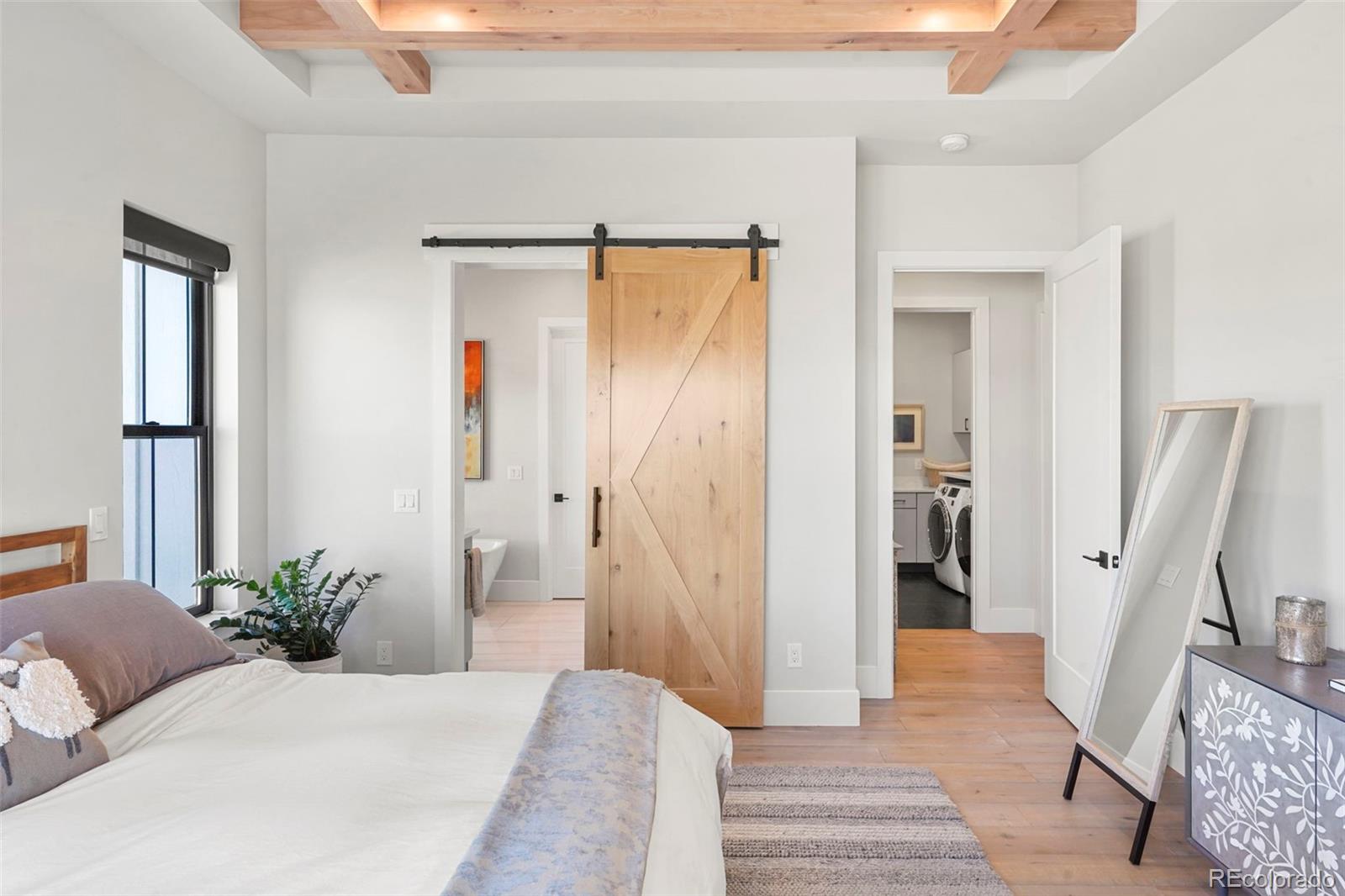 10621 Lone Fox Road Franktown, CO 80116 - Photo 23 of 50 a bedroom with a bed and a mirror