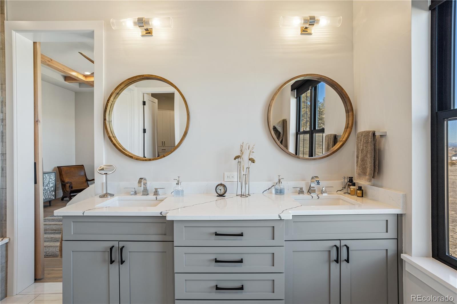 10621 Lone Fox Road Franktown, CO 80116 - Photo 24 of 50 a bathroom with a double vanity sink and a mirror