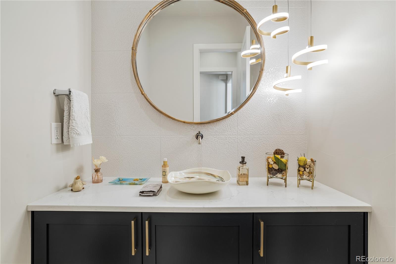 10621 Lone Fox Road Franktown, CO 80116 - Photo 30 of 50 a bathroom with a sink and a mirror