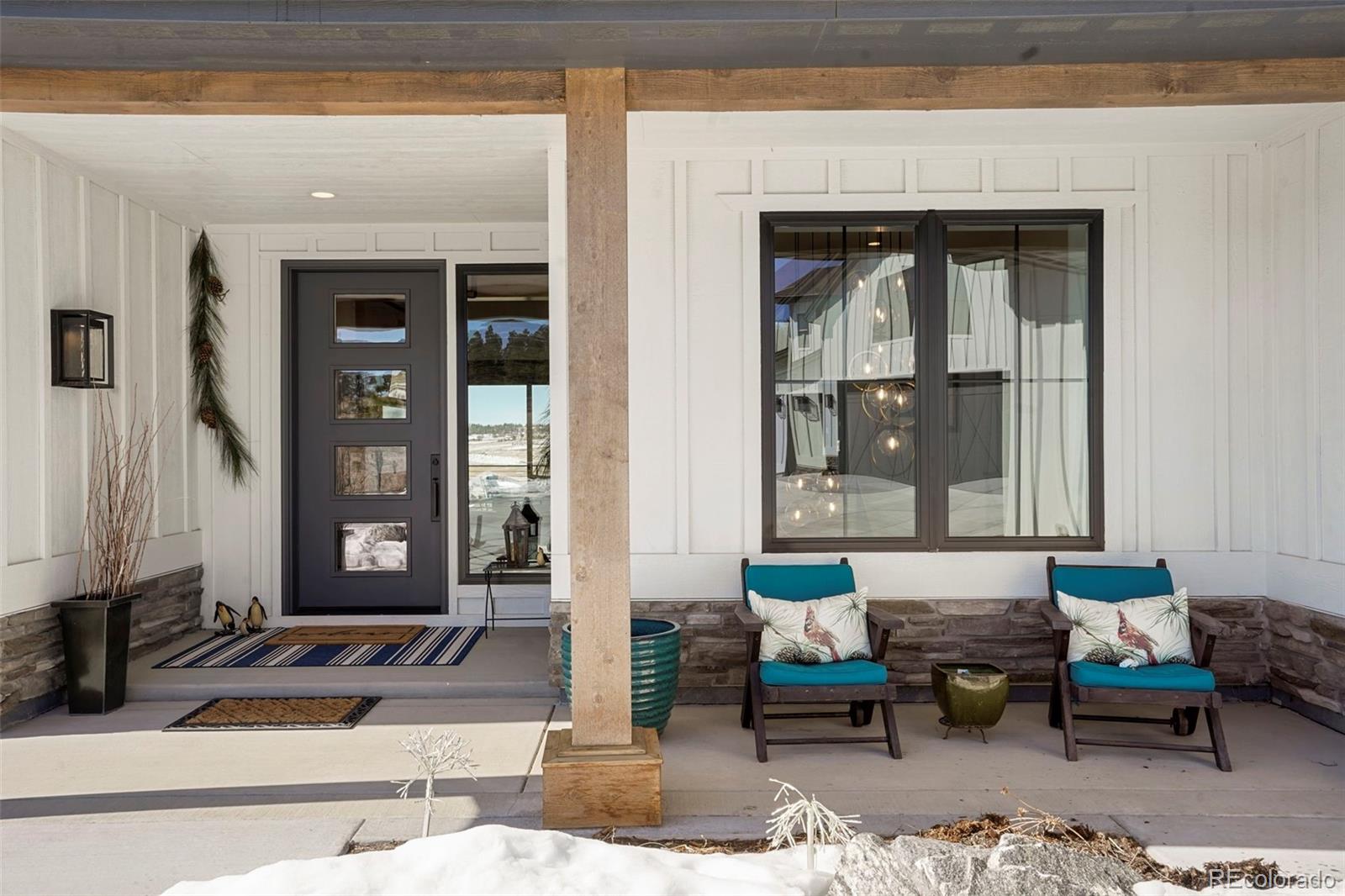 10621 Lone Fox Road Franktown, CO 80116 - Photo 3 of 50 a outdoor living space with furniture and rug