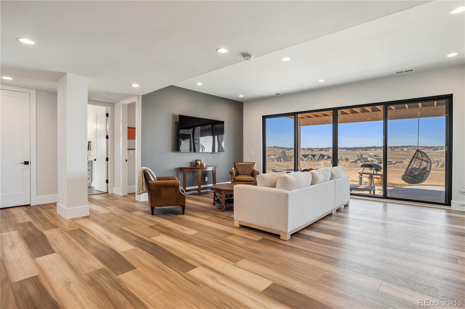 10621 Lone Fox Road Franktown, CO 80116 - Photo 36 of 50 a living room with furniture and a large window