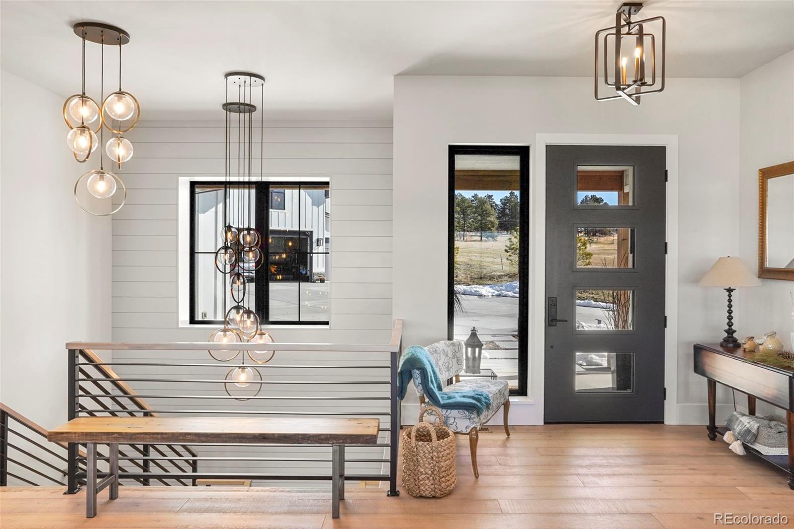 10621 Lone Fox Road Franktown, CO 80116 - Photo 4 of 50 a view of hall way with furniture and chandelier