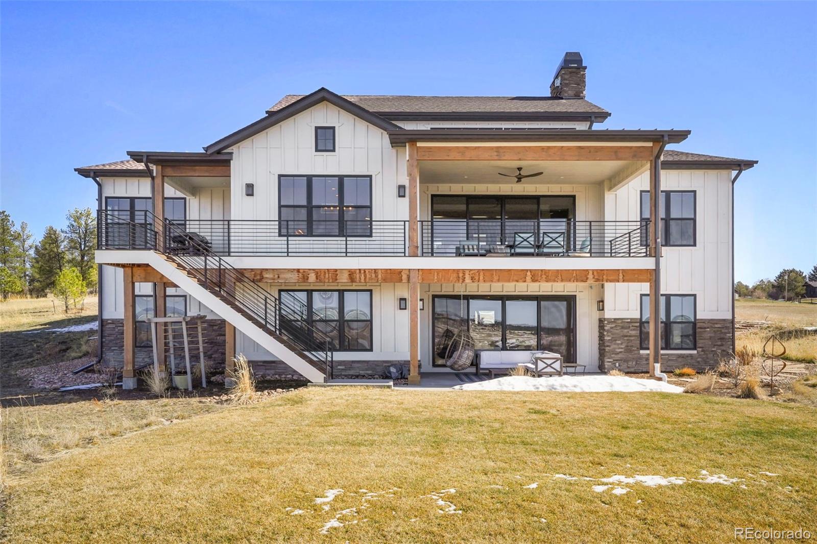 10621 Lone Fox Road Franktown, CO 80116 - Photo 42 of 50 a view of a building with a large windows