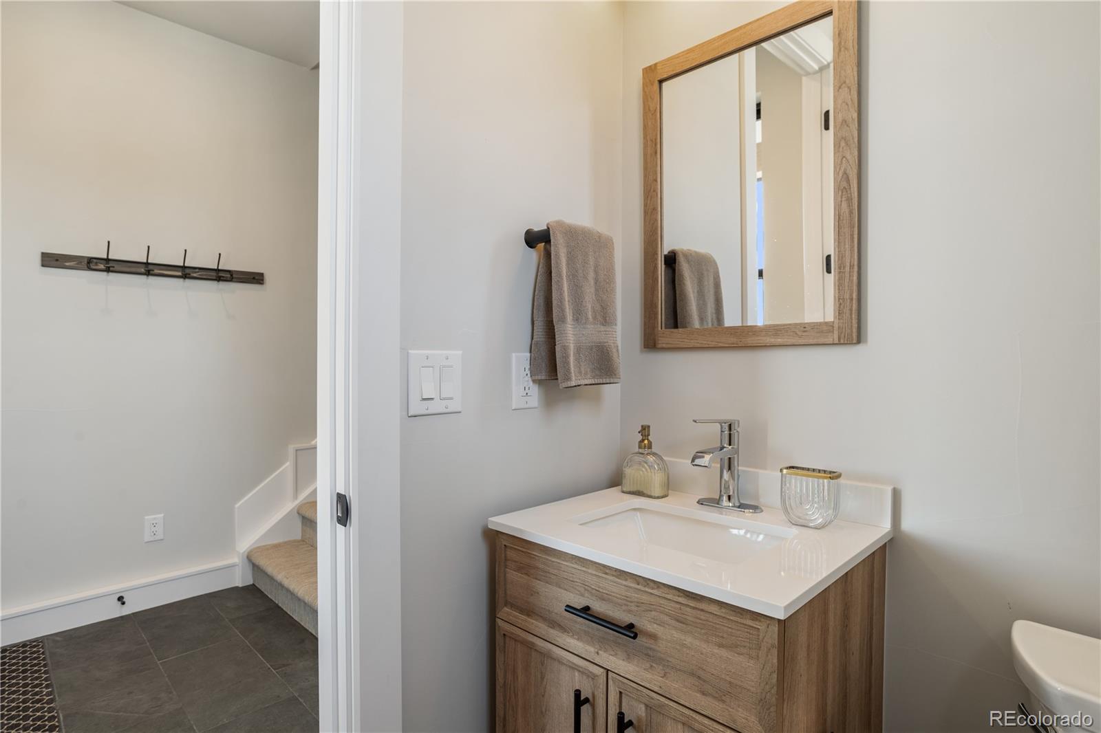 10621 Lone Fox Road Franktown, CO 80116 - Photo 47 of 50 a bathroom with a sink and a mirror