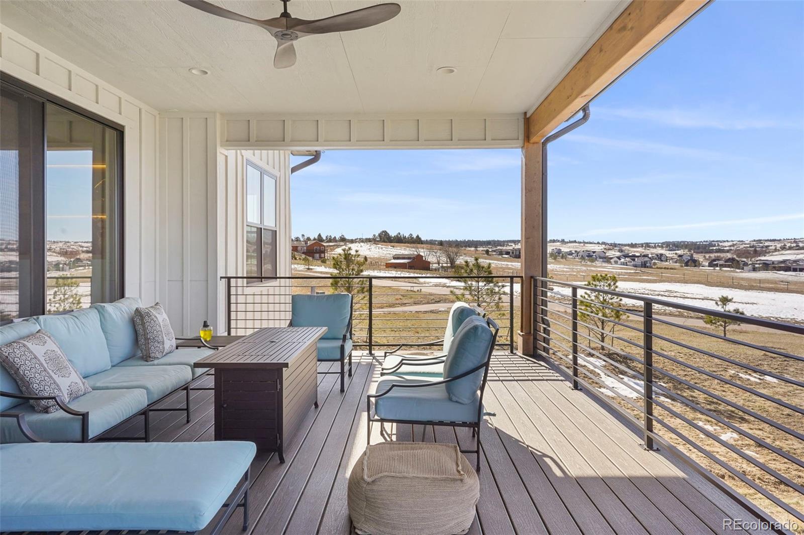 10621 Lone Fox Road Franktown, CO 80116 - Photo 8 of 50 a dining room with furniture and a floor to ceiling window