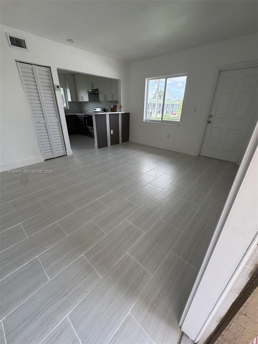 800 Northwest 44th Avenue, Unit 4 Miami, FL 33126 - Photo 2 of 16 a view of empty room with windows and cabinet