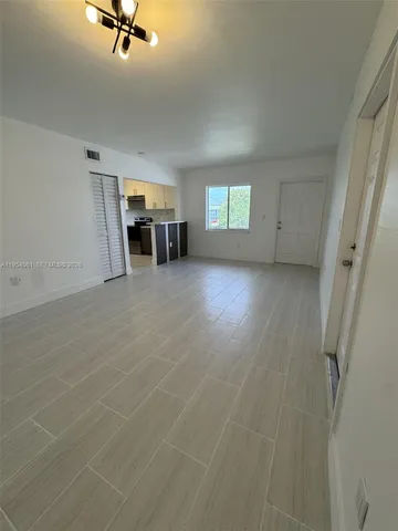 a view of a livingroom with a hardwood and furniture