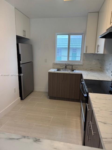 800 Northwest 44th Avenue, Unit 4 Miami, FL 33126 - Photo 5 of 16 a kitchen with stainless steel appliances granite countertop a refrigerator and a stove top oven