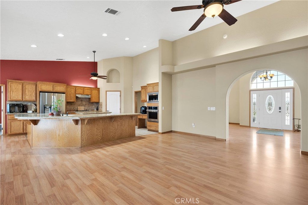 19501 Kinai Road Apple Valley, CA 92307 - Photo 11 of 69 a view of a kitchen with kitchen island a counter top space appliances and a ceiling fan