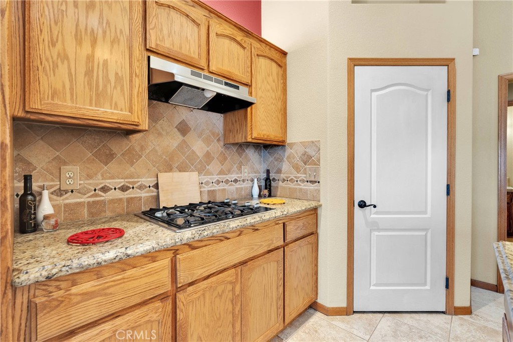 19501 Kinai Road Apple Valley, CA 92307 - Photo 19 of 69 a kitchen with stainless steel appliances granite countertop a sink stove and cabinets