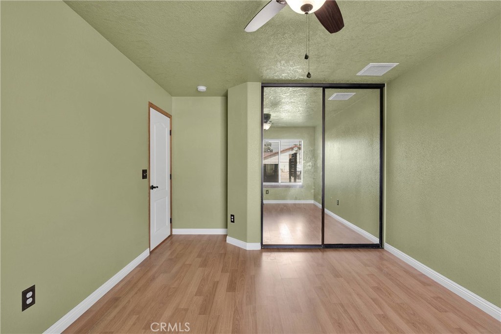 19501 Kinai Road Apple Valley, CA 92307 - Photo 29 of 69 a view of empty room with wooden floor