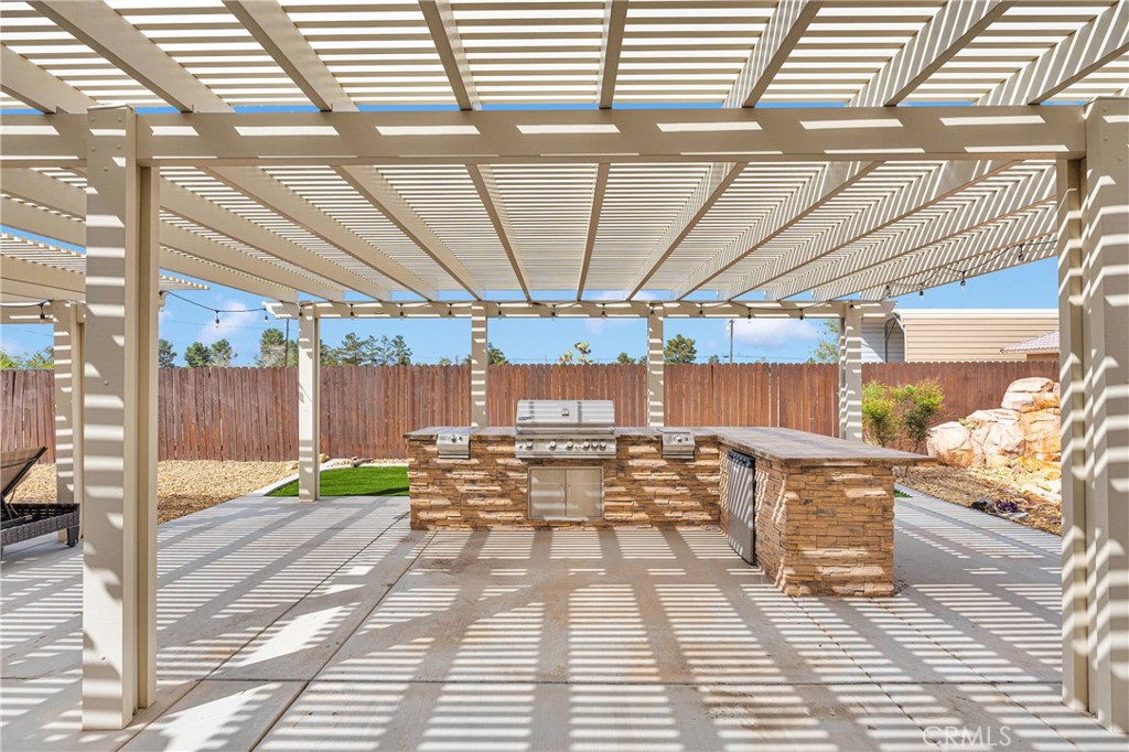 19501 Kinai Road Apple Valley, CA 92307 - Photo 46 of 69 a view of a patio with a table and chairs and wooden floor