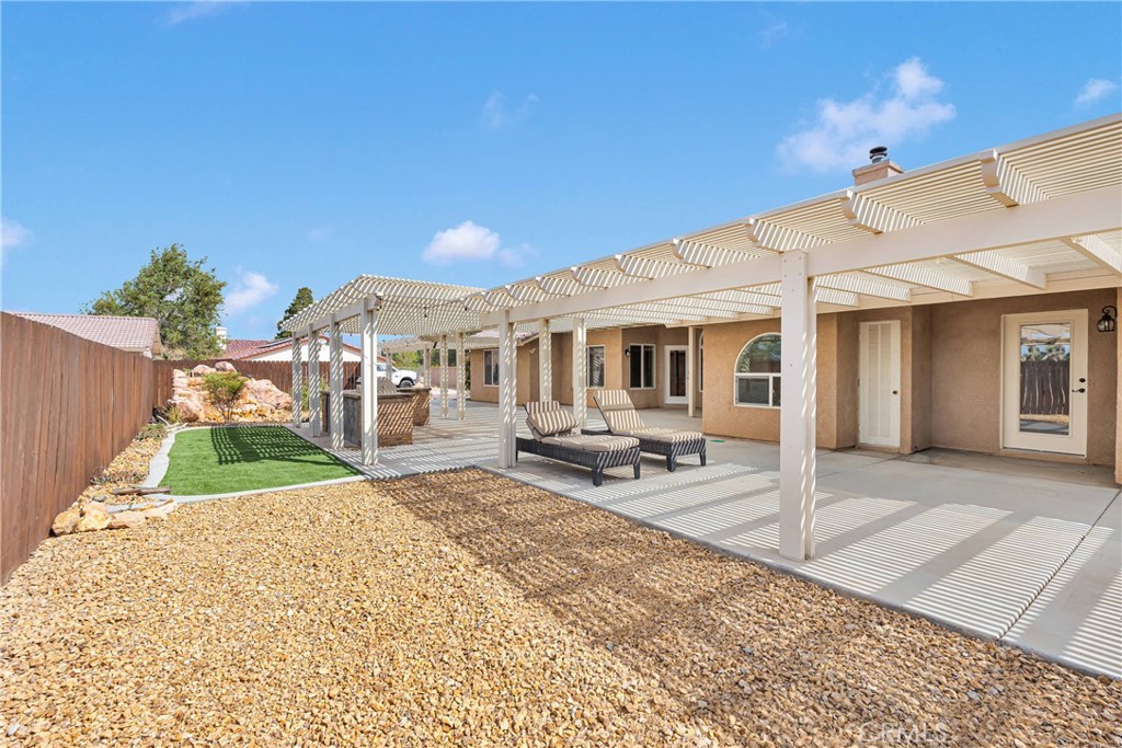 19501 Kinai Road Apple Valley, CA 92307 - Photo 50 of 69 a view of a house with backyard porch and sitting area