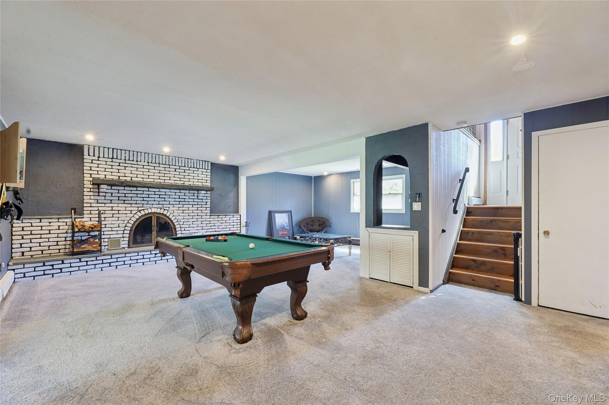 635 South Pascack Road Chestnut Ridge, NY 10977 - Photo 17 of 40 Expansive family room on the lower walkout level featuring new carpeting, amazing woos burning fireplace with brick and lovely built-ins