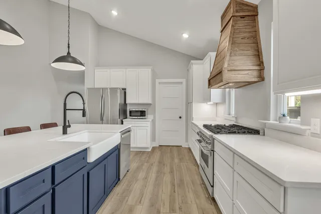 a bedroom with a large bed and a chandelier