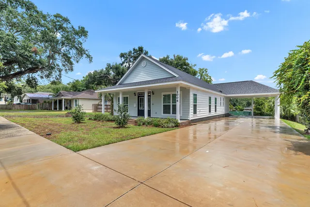 a front view of a house with yard and green space