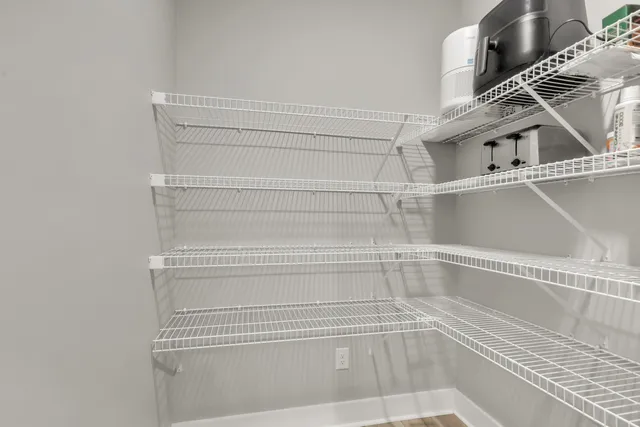 a bathroom with a sink a toilet a mirror and shower