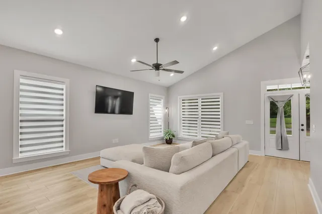 a view of a kitchen with kitchen island a stove a sink and a window