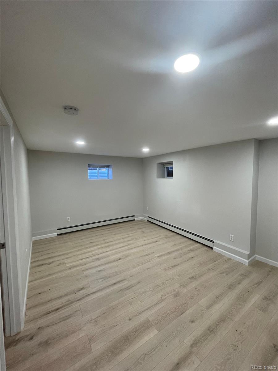 3210 West Longfellow Place Denver, CO 80221 - Photo 11 of 36 an empty room with wooden floor and windows