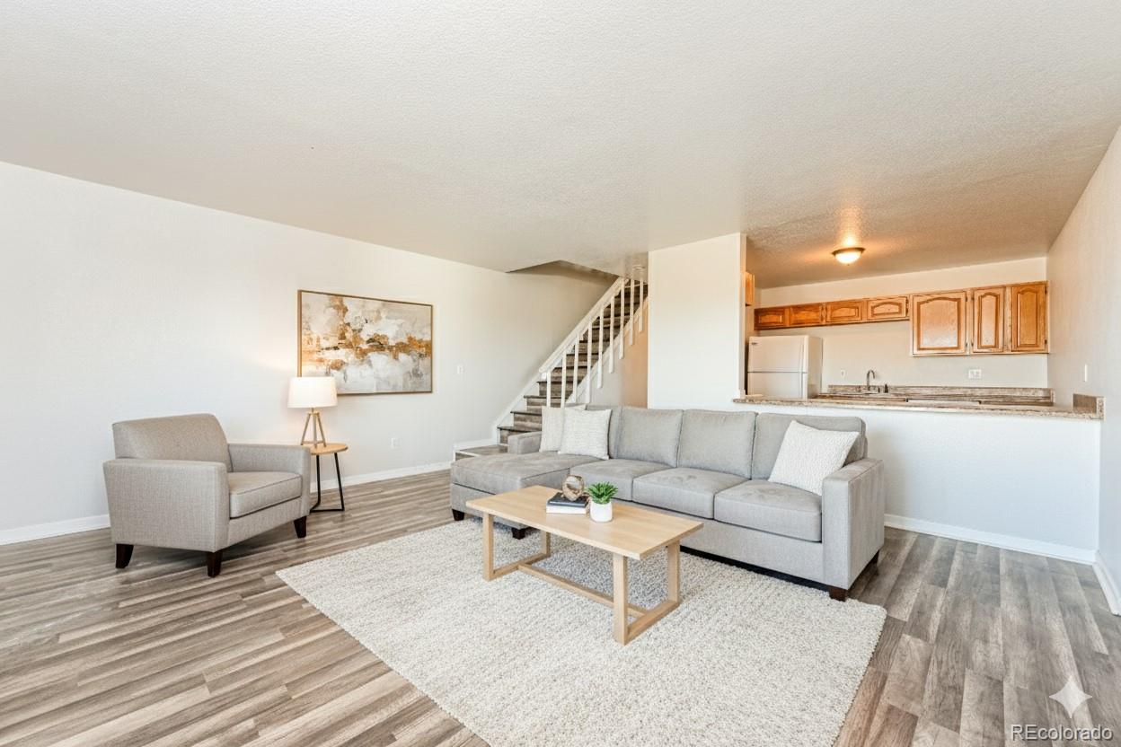 3210 West Longfellow Place Denver, CO 80221 - Photo 15 of 36 a living room with furniture and a wooden floor