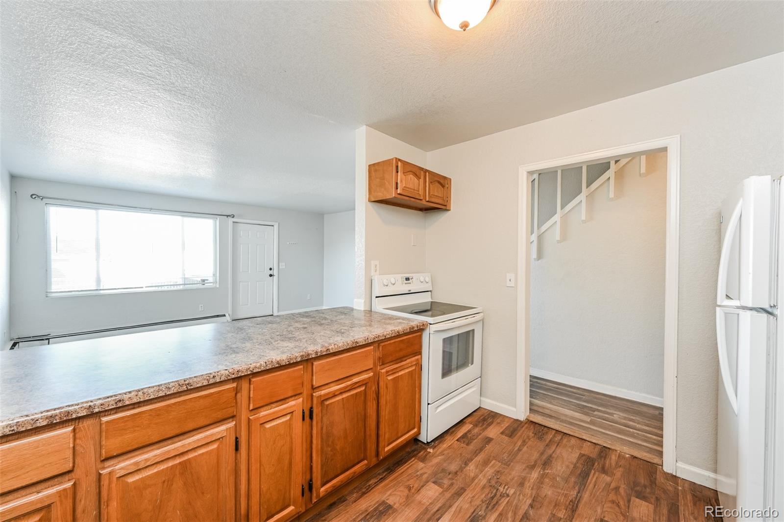 3210 West Longfellow Place Denver, CO 80221 - Photo 18 of 36 a kitchen with stainless steel appliances granite countertop a refrigerator and a sink