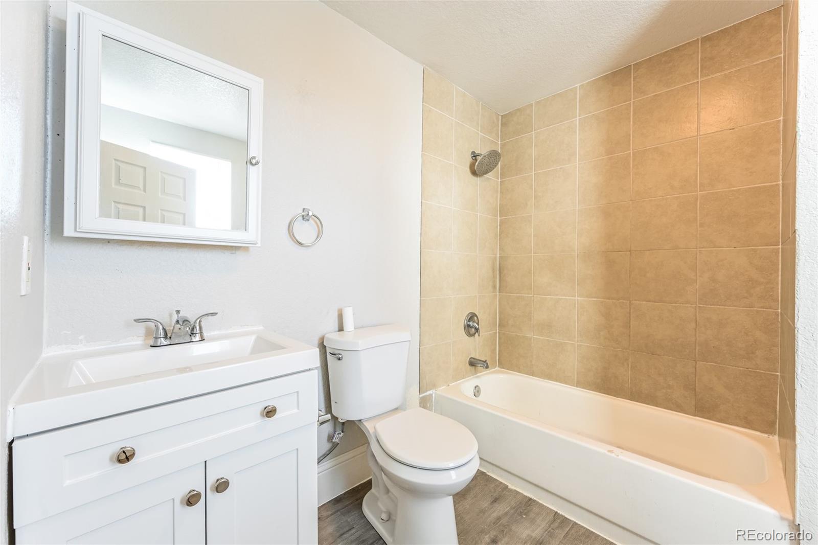 3210 West Longfellow Place Denver, CO 80221 - Photo 24 of 36 a bathroom with a sink toilet and shower