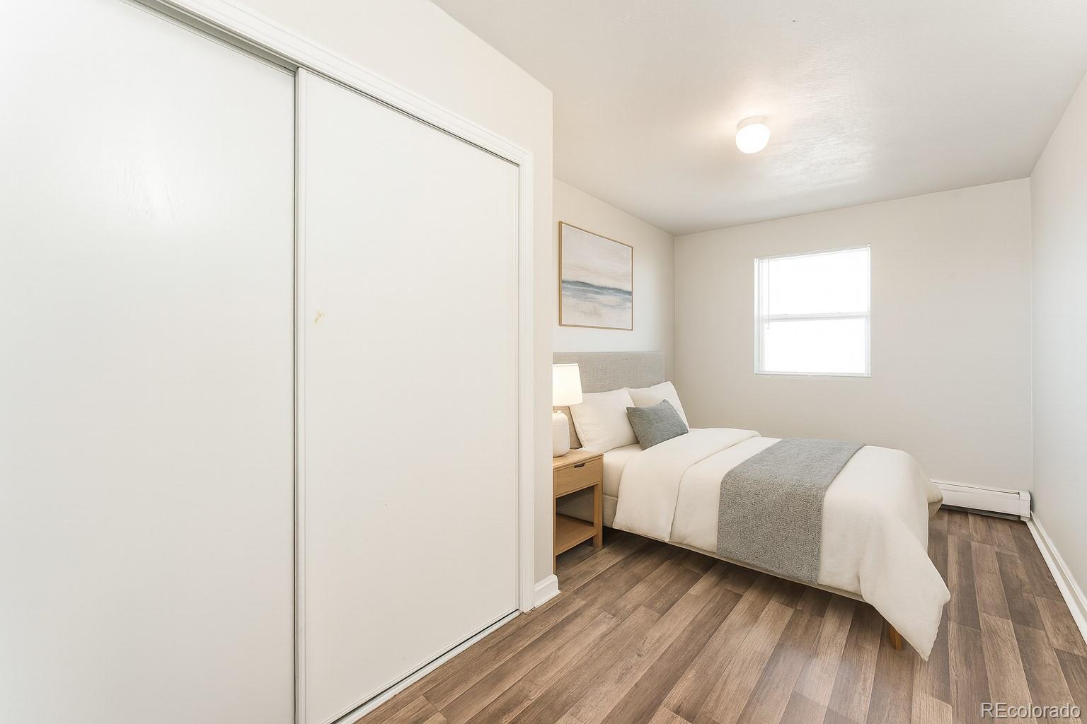 3210 West Longfellow Place Denver, CO 80221 - Photo 29 of 36 a room with a bed and a window