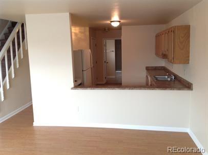 3210 West Longfellow Place Denver, CO 80221 - Photo 30 of 36 a view of a livingroom with kitchen and furniture