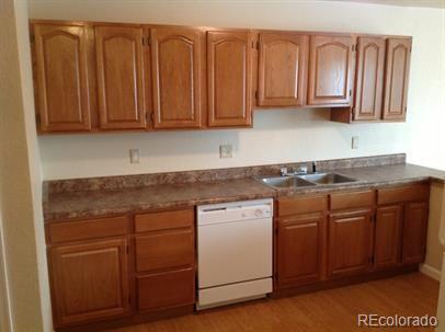 3210 West Longfellow Place Denver, CO 80221 - Photo 31 of 36 a kitchen with stainless steel appliances granite countertop wooden cabinets a sink and dishwasher